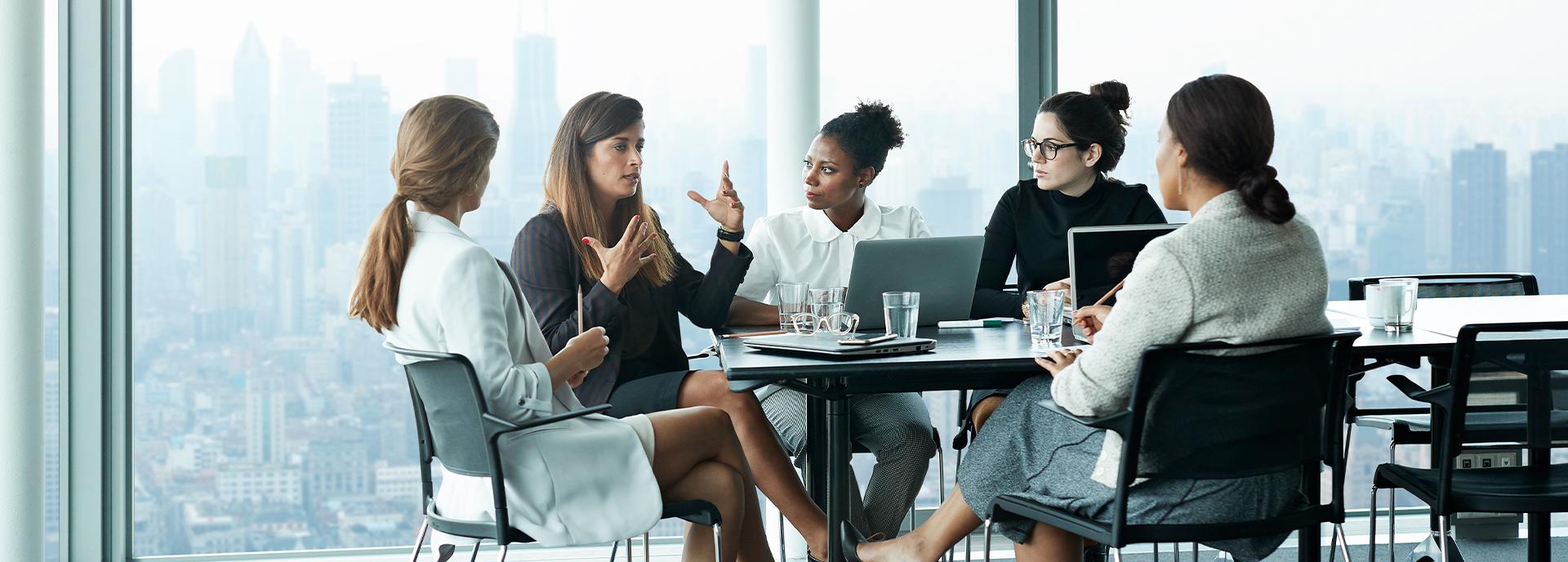 Group of inspiring women in financial services speaking together