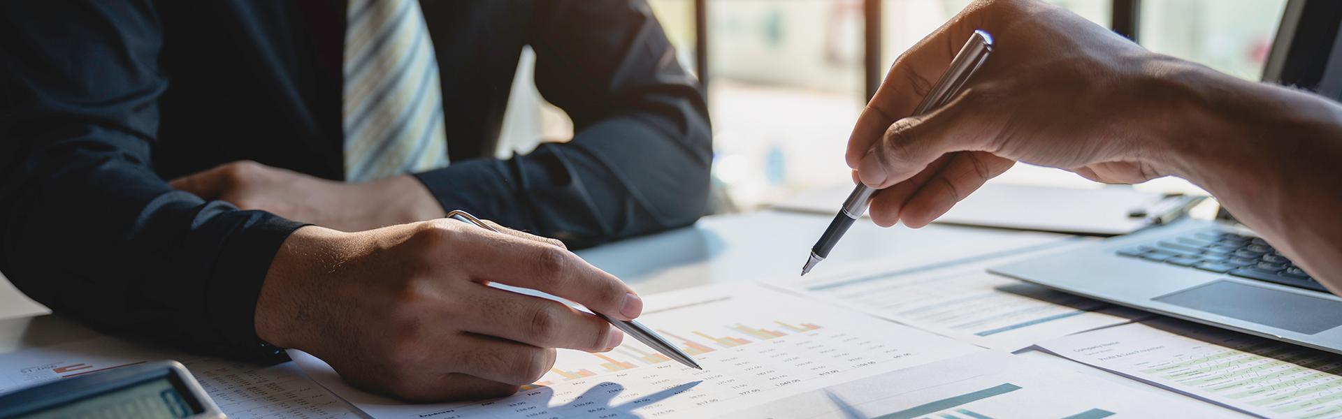 Group of financial advisors working on a spreadsheet together