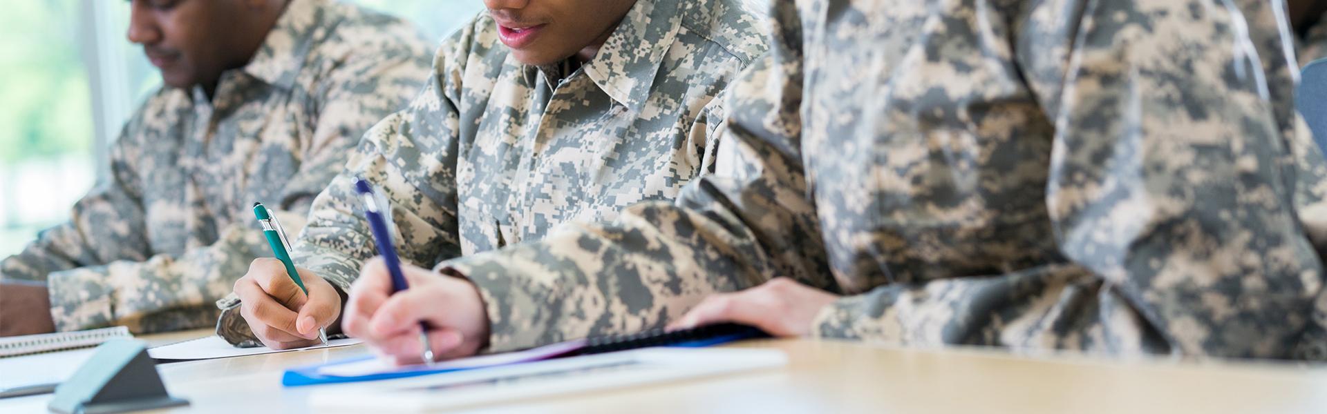 Group of military servicemen writing letters