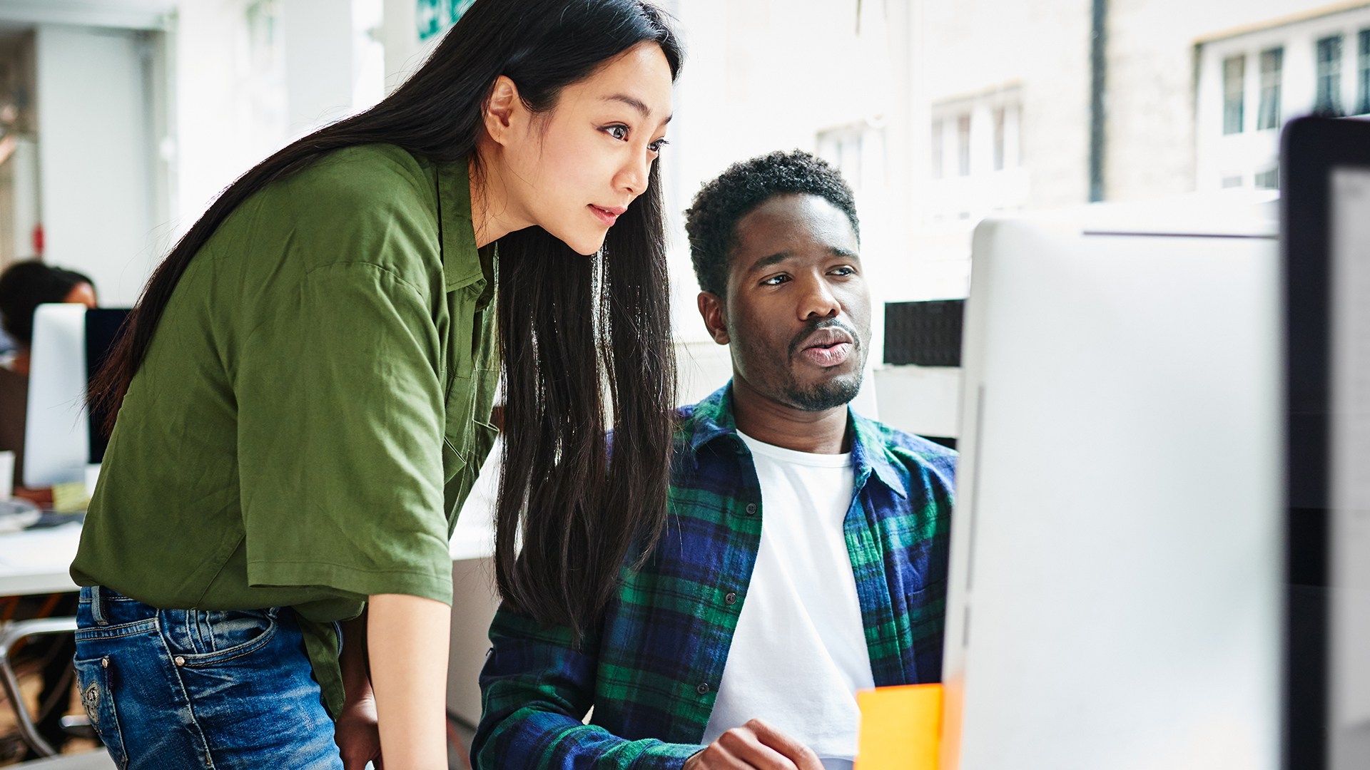 Asian women and black man working together