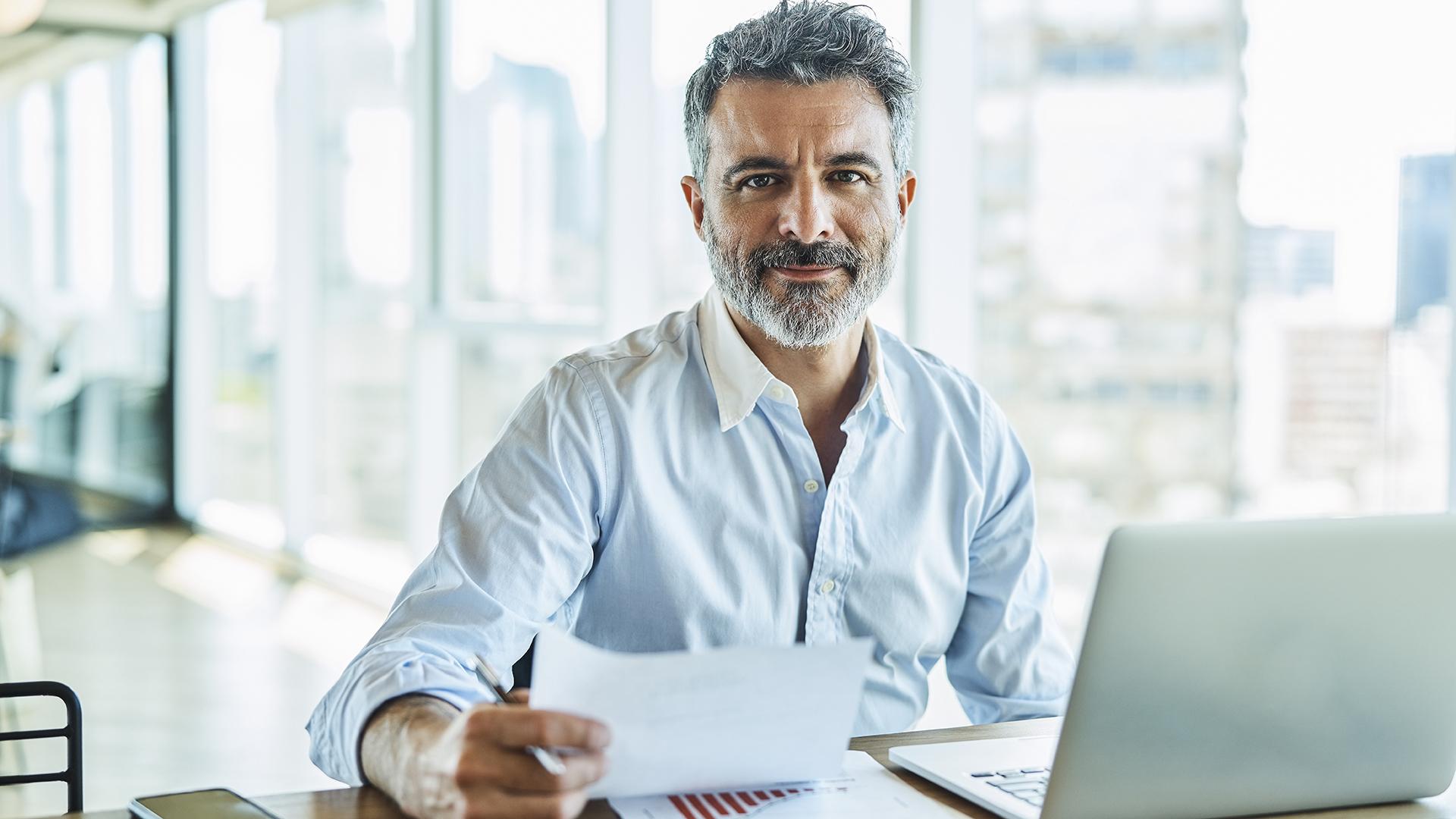 Middle aged man sitting at his desk working