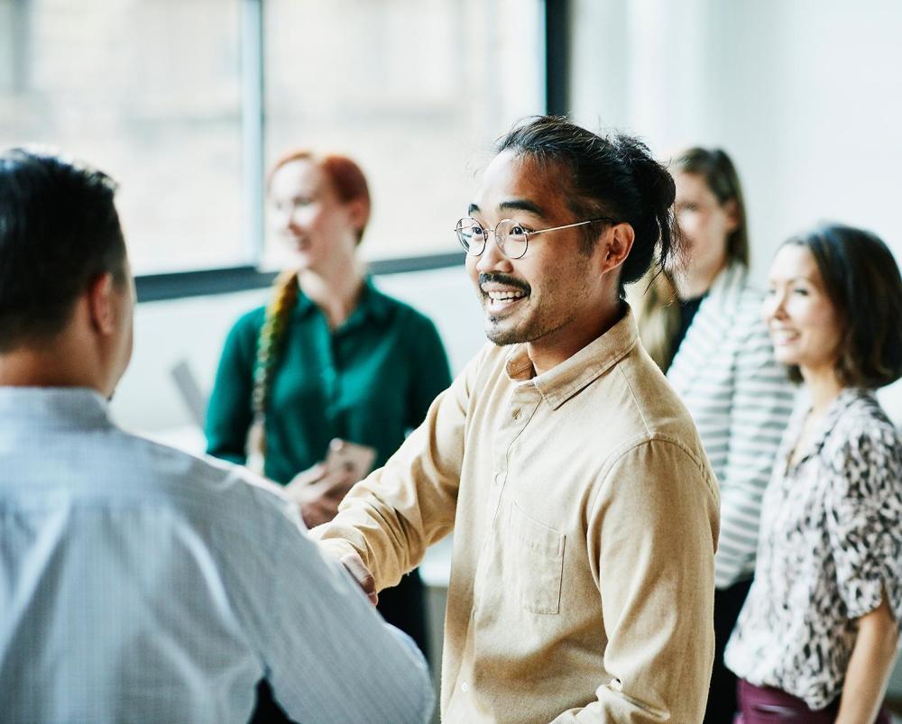 Group of professionals shaking hands at a networking event