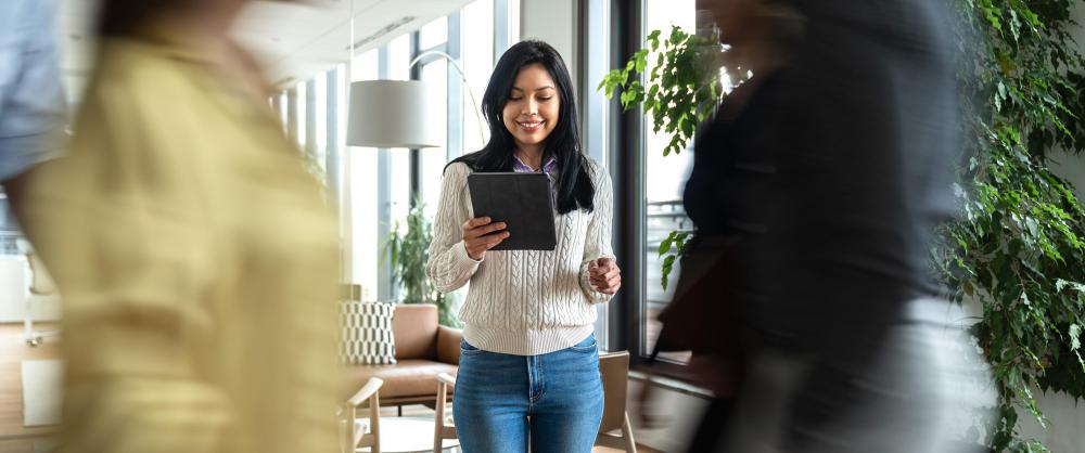 Young professional woman reading financial advice on tablet