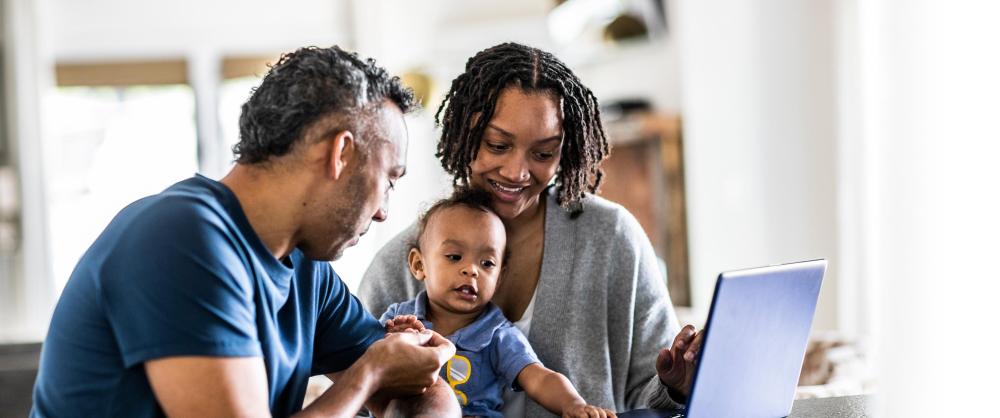 Young family using laptop at home