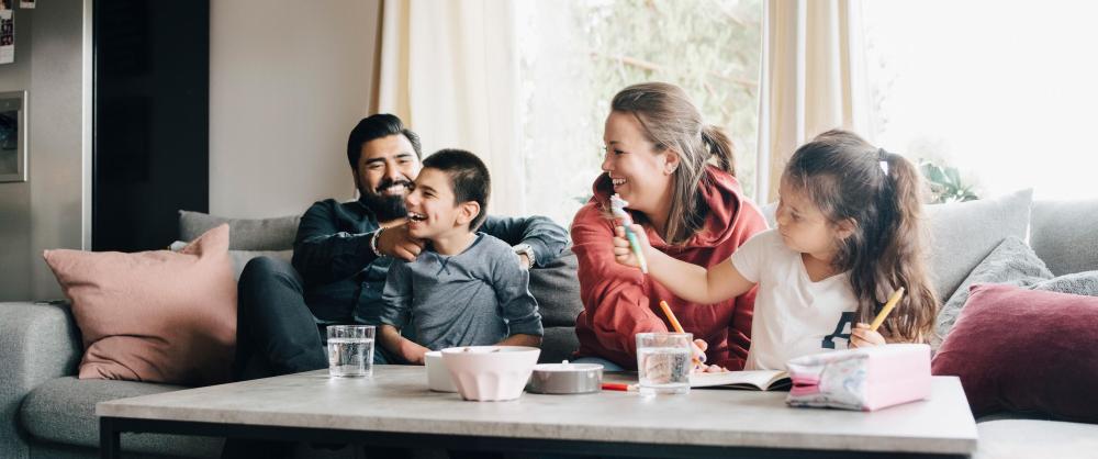 Family of special needs children playing together in the living room