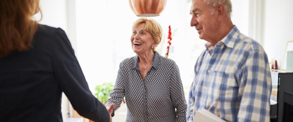 Elderly couple discussing retirement options with an RICP