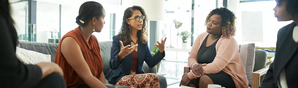 Professional businesswoman talking to a diverse group