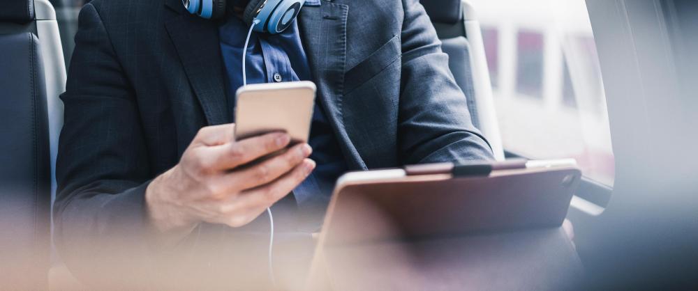 Man looking at a phone and tablet