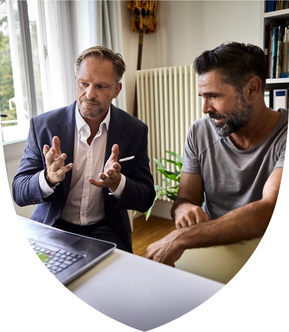 Two men talking at a table