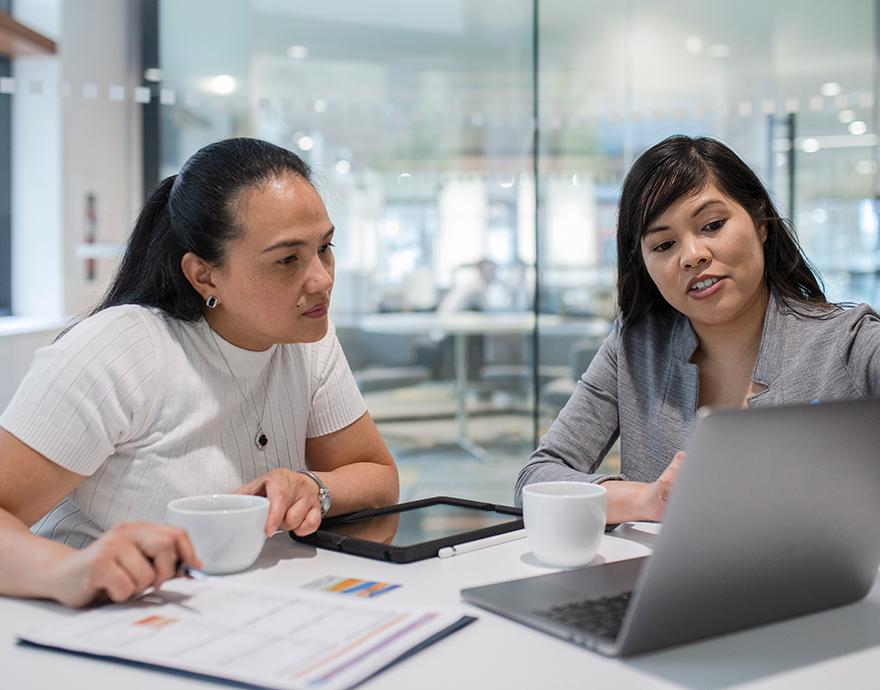 Two women looking at a laptop