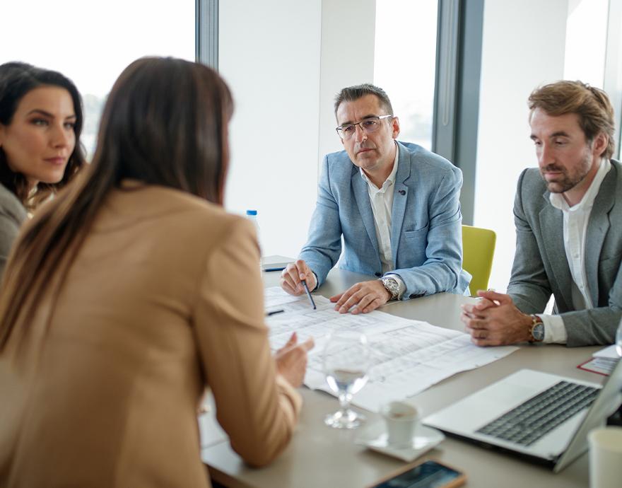 A meeting of 4 people around a table