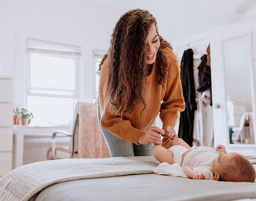 Woman changing a baby's diaper