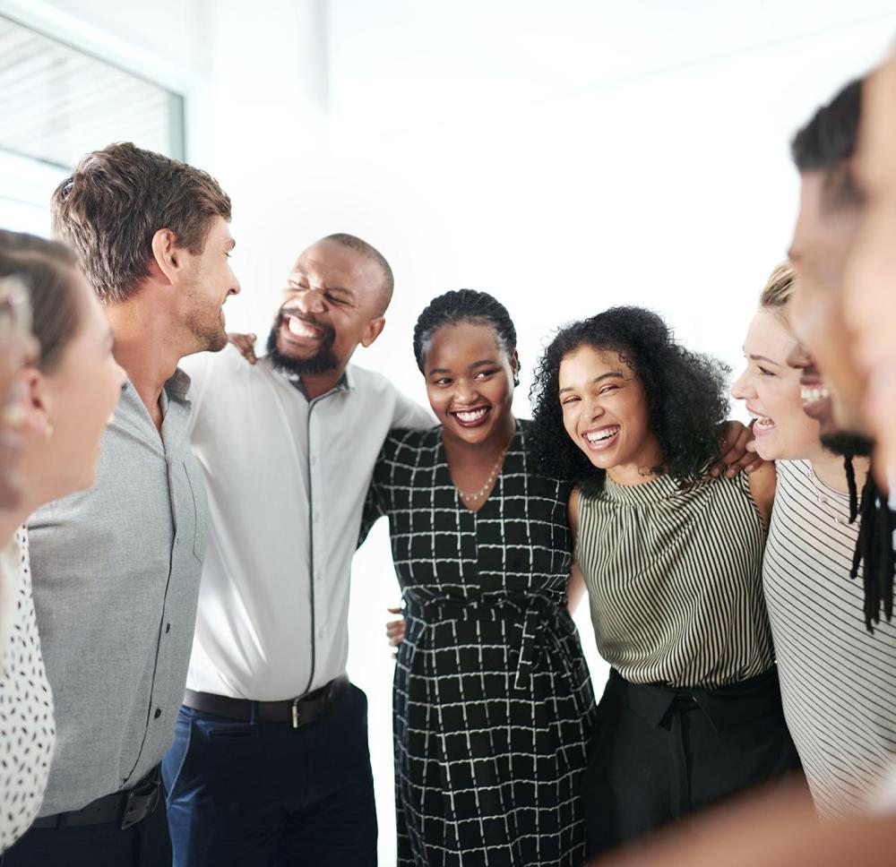 Image of a group of people with their arms around each other