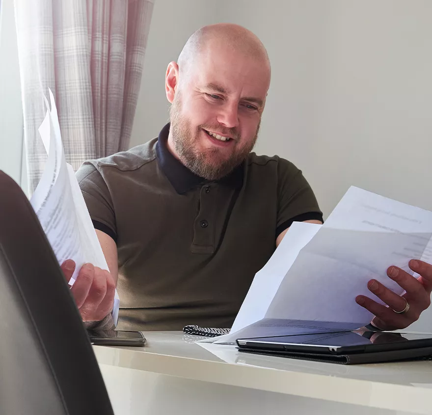 Man looking at pieces of paper