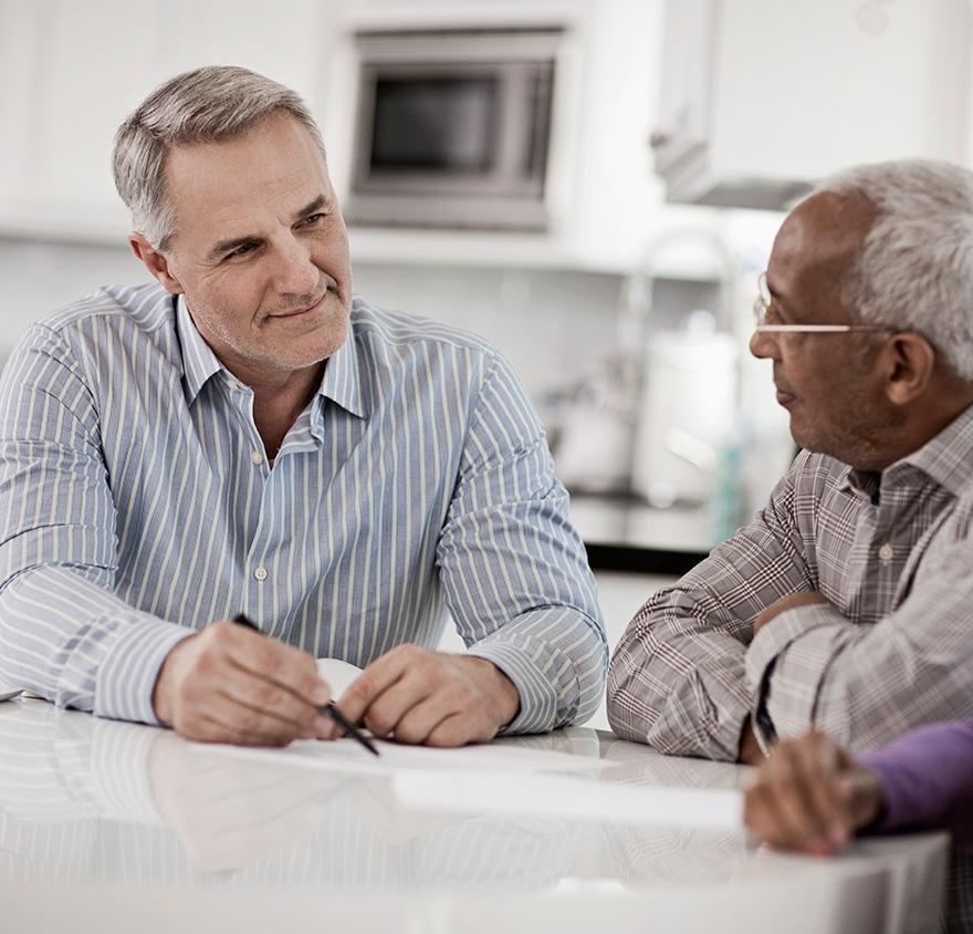 Two men talking at a table