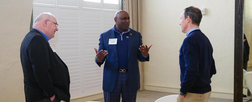 George Nichols speaking with two attendees