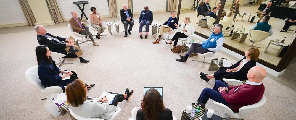 Attendees speaking in a circle with George Nichols