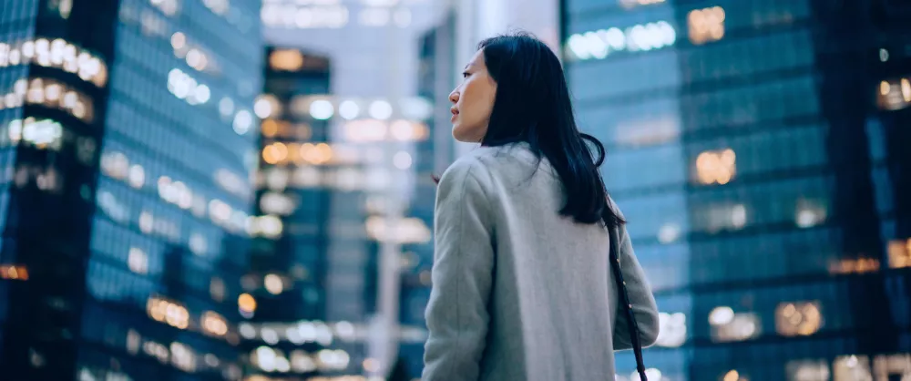 Woman looking at city building