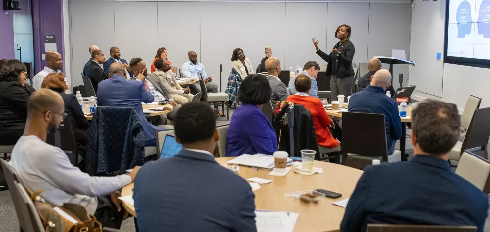 A woman speaking to a group of people