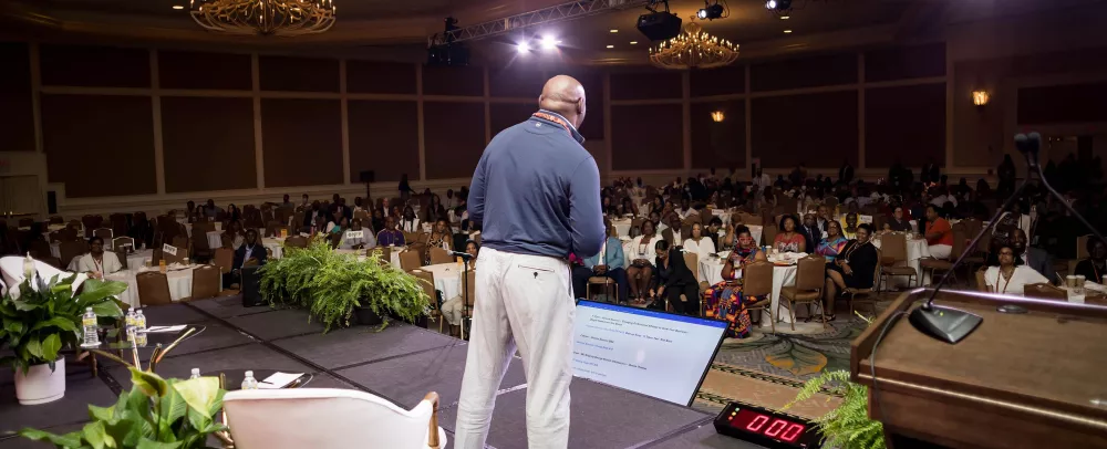 George talking to a crowd of people