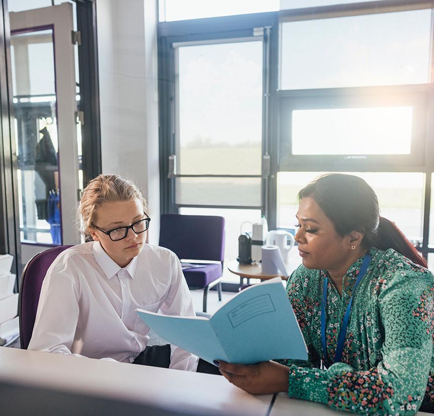 Professor working with student to study for certificate 