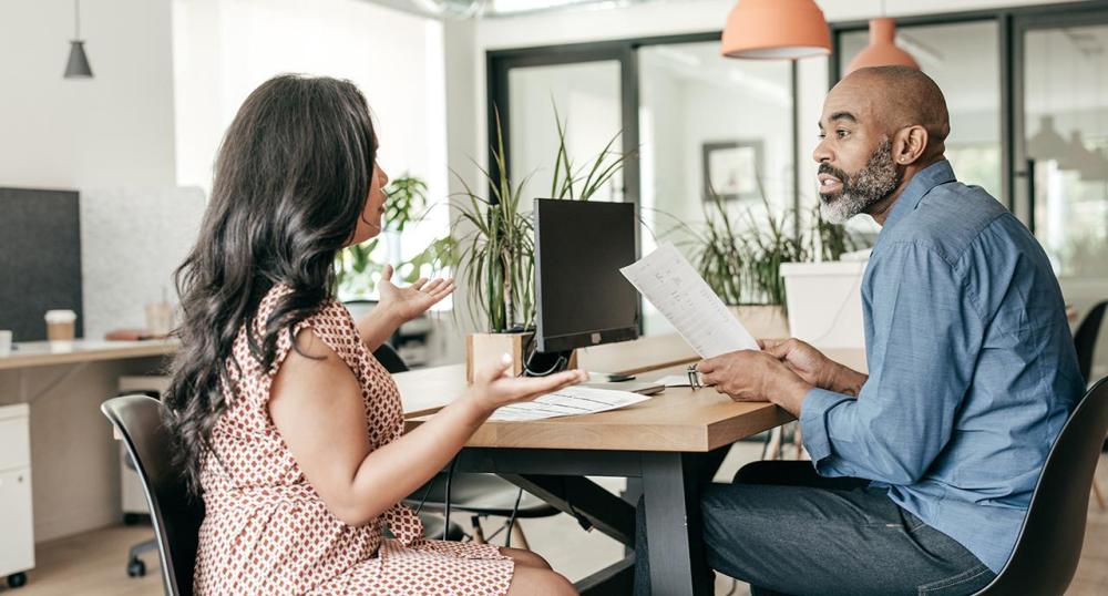 Two work colleagues talking together