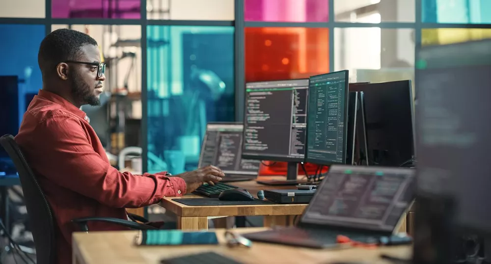 Man working at his desk with AI technology