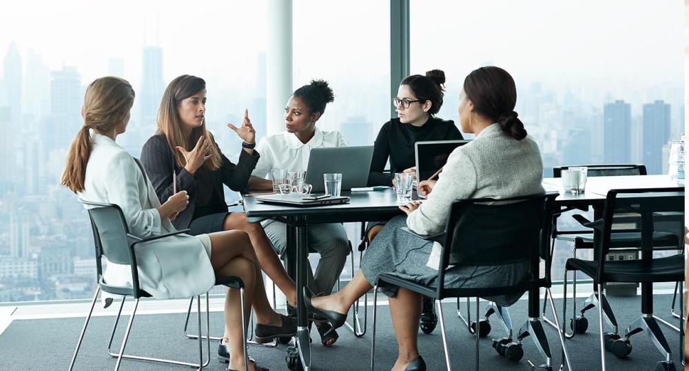 Group of inspiring women in financial services speaking together