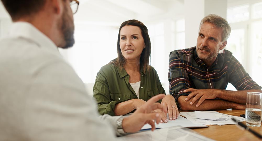 A couple speaking with an advisor about retirement options