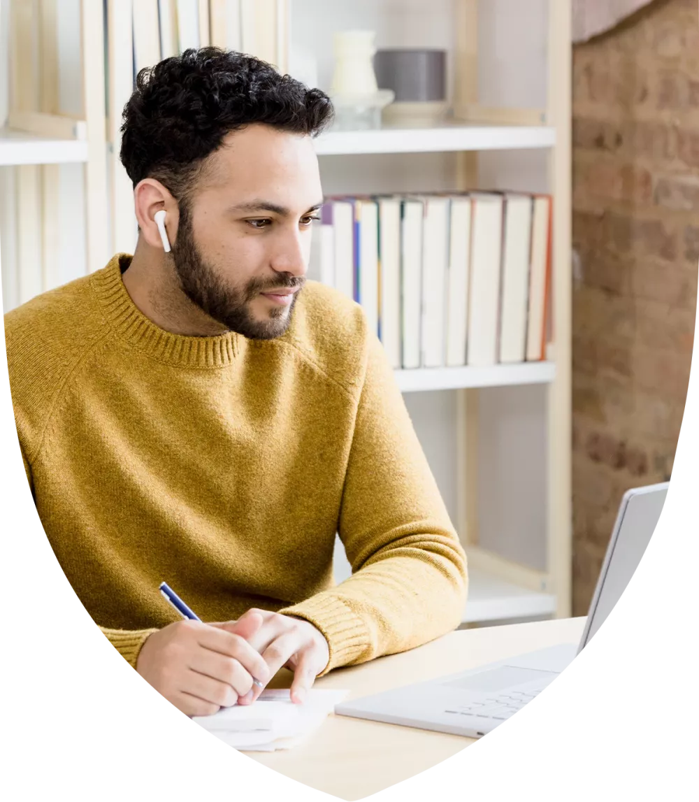 Man at his desk studying for the CFP exam