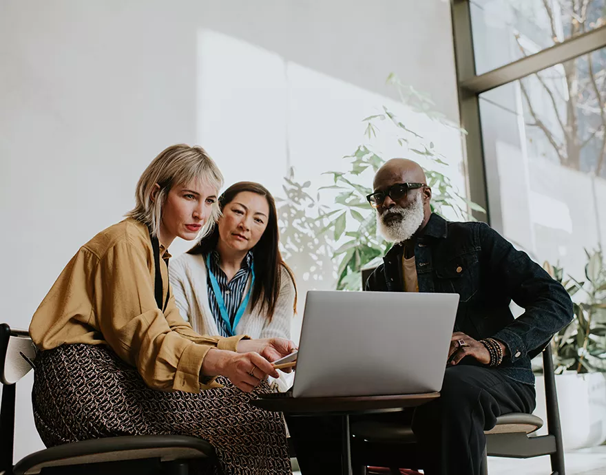 Group of financial advisors researching recertification programs