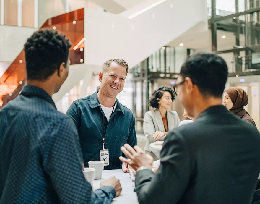 Three men networking together at a conference