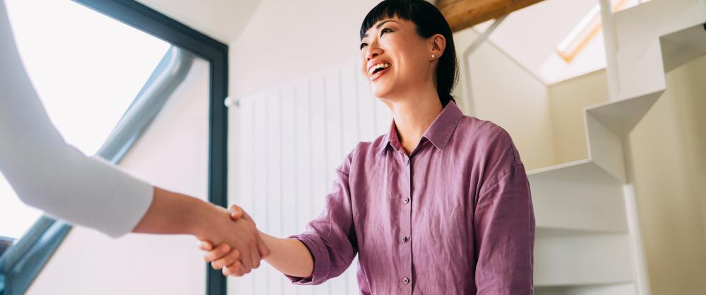 Advisor and their client happily shaking hands