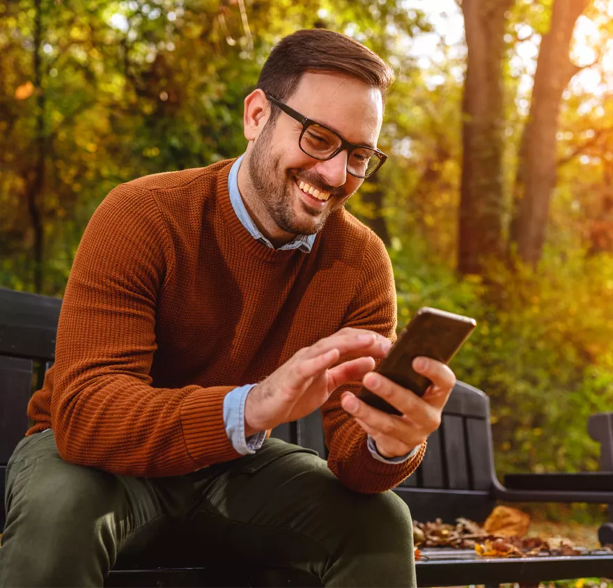 Male young professional smiling in the park