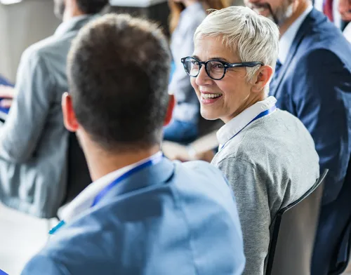 Woman smiling while at an in person event