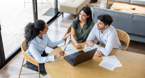 Female financial advisor meeting with a married couple