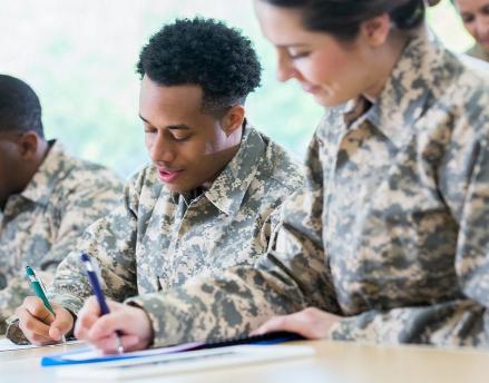 Group of military servicemen writing letters